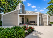 Thumbnail 6 of 9 - A modern house with a grey exterior and a small garden in front.