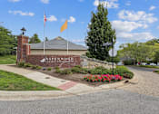 Thumbnail 26 of 26 - The Aspenwood Luxury Estate sign is displayed on a brick building.