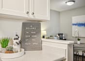 Thumbnail 9 of 24 - A sign that says "Welcome to your new home at the Felix Apartments" is displayed in a kitchen.