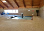 Thumbnail 54 of 58 - a large indoor jacuzzi in a building with wood ceilings and flooring