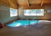 Thumbnail 53 of 58 - a swimming pool inside of a building with a pool