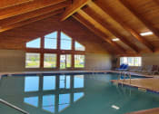 Thumbnail 50 of 58 - the indoor pool of a resort with a wooden ceiling and glass windows