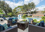 Thumbnail 3 of 17 - a pool with lounge chairs and a table at Parkland at Orange Park Apartments , Orange Park, FL, 32073