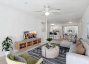Thumbnail 1 of 20 - A living room with a television, a sofa, a chair, a table, and a plant.