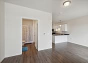 Thumbnail 19 of 56 - a spacious living room and kitchen with white walls and wood flooring