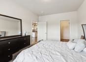 Thumbnail 24 of 56 - a bedroom with a large white bed and a mirror
