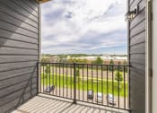 Thumbnail 30 of 56 - a balcony with a view of a yard and a balcony fence