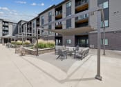 Thumbnail 38 of 56 - a patio with tables and chairs in front of a building
