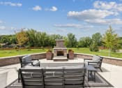 Thumbnail 40 of 56 - a patio with chairs and a fire pit