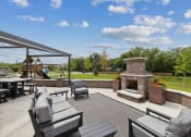 Thumbnail 43 of 56 - a large patio with furniture and a stone fireplace