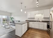 Thumbnail 5 of 56 - an open kitchen and living room with a couch and a table