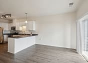 Thumbnail 9 of 56 - a kitchen and living room with a large window and