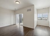 Thumbnail 17 of 56 - an empty living room with hard wood floors and a window