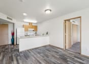 Thumbnail 2 of 31 - the living room and kitchen in a renovated apartment with wood flooring