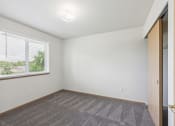 Thumbnail 9 of 31 - an empty living room with a large window and a carpet