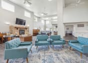 Thumbnail 22 of 31 - the preserve at ballantyne commons community living room with blue chairs and a fireplace