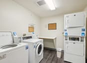 Thumbnail 30 of 31 - a laundry room with washes and dryers and a counter with a washer