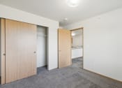 Thumbnail 8 of 31 - a bedroom with a door to a closet and a bathroom