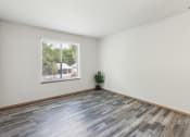 Thumbnail 3 of 31 - an empty room with wood floors and a window
