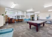Thumbnail 23 of 31 - a games room with a pool table in the middle