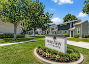 Thumbnail 1 of 9 - A sign that says Parkview Apartments is in front of some houses.