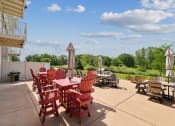 Thumbnail 56 of 58 - a patio with tables and chairs and umbrellas on the patio of a building