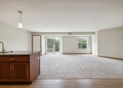 Thumbnail 34 of 58 - an empty living room and kitchen with wood flooring and a window