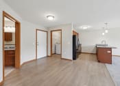 Thumbnail 31 of 58 - a kitchen and living room with wood flooring and a refrigerator and a sink