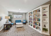 Thumbnail 37 of 58 - a living room with bookshelves and a couch and a table