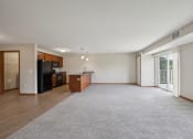 Thumbnail 20 of 58 - a spacious living room with a kitchen and a sliding glass door