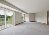 Thumbnail 23 of 58 - an empty living room with sliding glass doors to a balcony