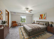 Thumbnail 1 of 58 - A bedroom with a bed, chair, and a painting on the wall.