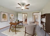 Thumbnail 2 of 58 - A room with a ceiling fan and a desk with a chair.