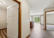 Thumbnail 11 of 58 - an open door leading into a living room and a kitchen