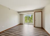 Thumbnail 6 of 58 - an empty living room with a door to a balcony
