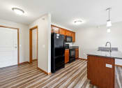 Thumbnail 5 of 58 - a kitchen with a black refrigerator and a counter top