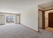 Thumbnail 9 of 58 - an empty living room with a door to a balcony