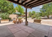 Thumbnail 2 of 39 - a patio with a table and an umbrella