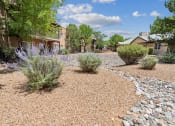 Thumbnail 4 of 39 - a yard with gravel and plants and houses