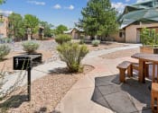 Thumbnail 5 of 39 - a patio with tables and benches in front of a building