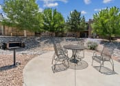 Thumbnail 16 of 39 - A patio with a table and chairs.