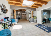 Thumbnail 23 of 39 - a living room with blue chairs and a rug and a fireplace