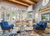 Thumbnail 24 of 39 - a living room with a couch and chairs and a fireplace