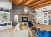 Thumbnail 37 of 39 - a living room with a fireplace and a large clock on the wall