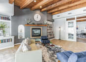 Thumbnail 35 of 39 - a living room with a couch and a clock on the wall