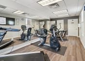 Thumbnail 28 of 39 - a gym with cardio equipment and exercise machines