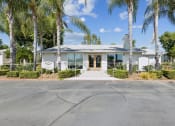 Thumbnail 18 of 20 - the front of a white house with palm trees