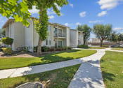 Thumbnail 16 of 20 - our apartments have a walkway with grass and trees