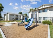 Thumbnail 4 of 20 - our apartments have a playground with a slide and chairs