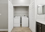 Thumbnail 11 of 26 - A laundry room with a washer and dryer in it.